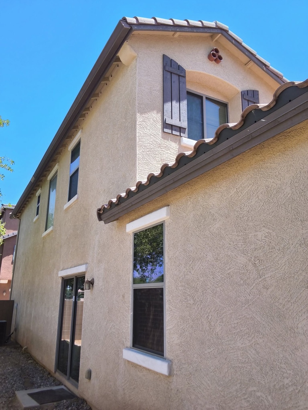 Home exterior with fresh stucco and shutter paint